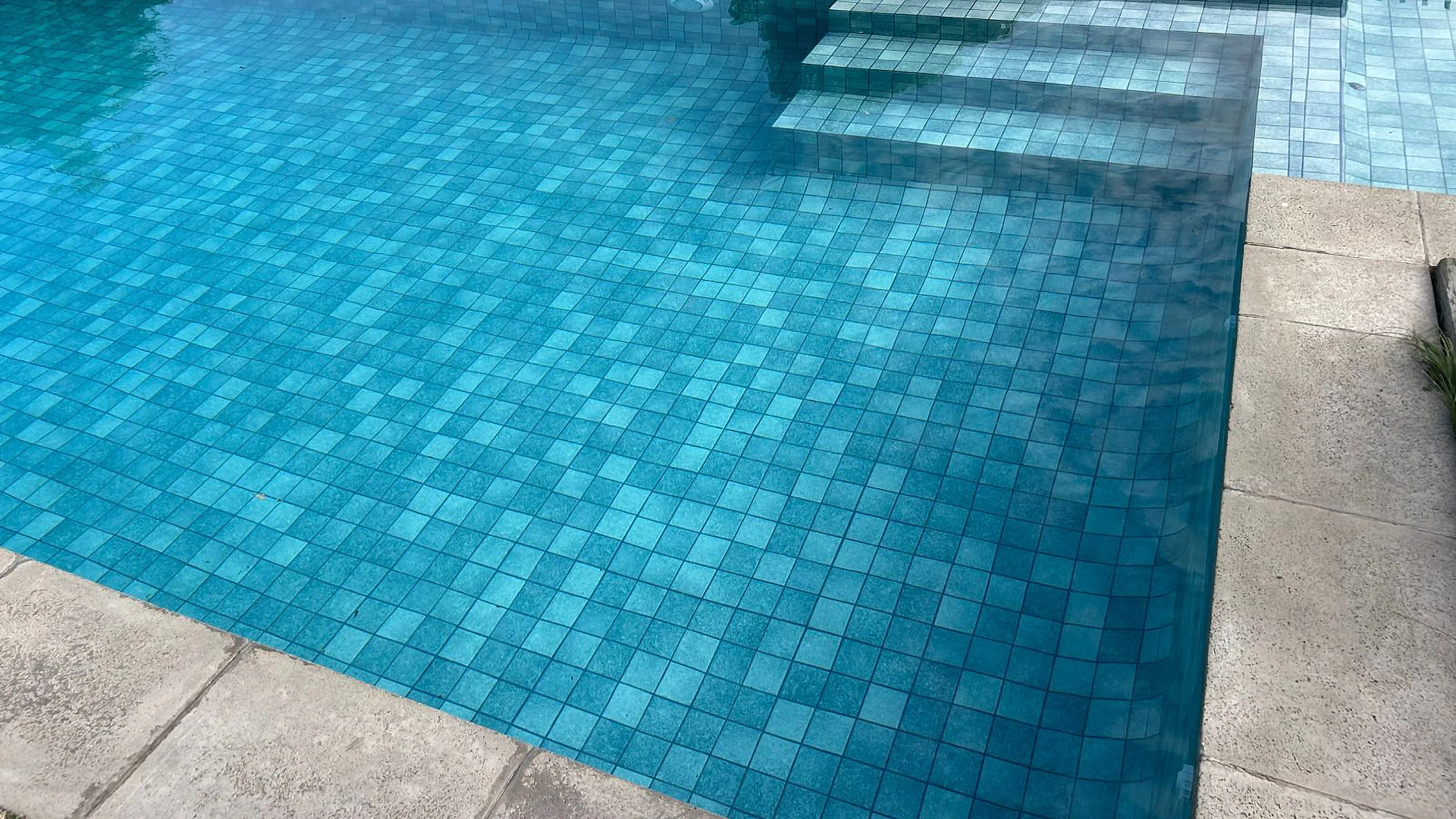 Piscina moderna con revestimiento Pedra Bela y tonos naturales